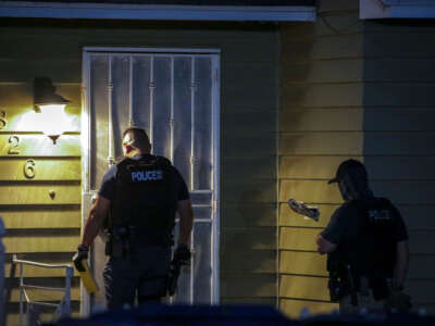 Crypto and Customs Enforcement officials knock at the door of a house on September 8, 2022, in Los Angeles, California.